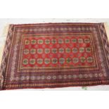 Pakistan rug of Bokhara design with three rows of gols on a red ground with borders, 6ft 2ins x