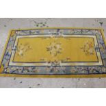 Small Chinese rug with floral design on yellow ground, 5ft 8ins x 3ft 2ins approximately together