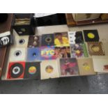 Quantity of 1980's vinyl singles in a black case