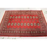 Two Pakistan Bokhara rugs on wine ground, each approximately 70ins x 48ins