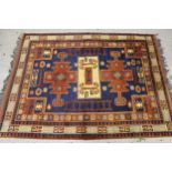 Small Turkish carpet, with a triple medallion and all over design, on a royal blue ground, with