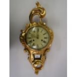 Reproduction gilt wood cartel type clock, the enamel dial with Roman and Arabic numerals, with a two