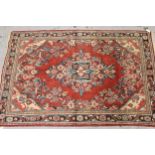 Sarouk rug with a medallion and floral design, on rose ground with borders, 6ft 8ins x 4ft 6ins