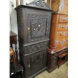 19th Century French narrow carved oak side cabinet, the moulded cornice, with a carved surmount,