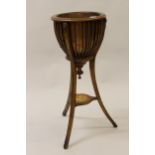 Reproduction mahogany and inlaid jardiniere stand in Victorian style, the moulded basket work top