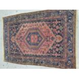 Hamadan rug with a lobed hooked medallion and all over stylised design on a rose ground with blue