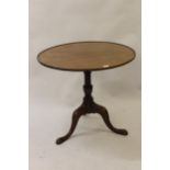 George III mahogany circular pedestal table, the tilt dish top above a baluster turned column