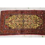 Small Saruq rug with an all over stylised floral design, on a pale yellow ground with borders, 4ft