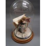Naples porcelain figure of a dentist, with young girl under a glass dome on mahogany circular