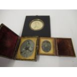 Two leather cased Ambrotypes and a circular mounted portrait