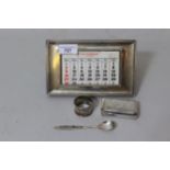 London silver mounted desk calendar, antique silver snuff box, a napkin ring and a spoon