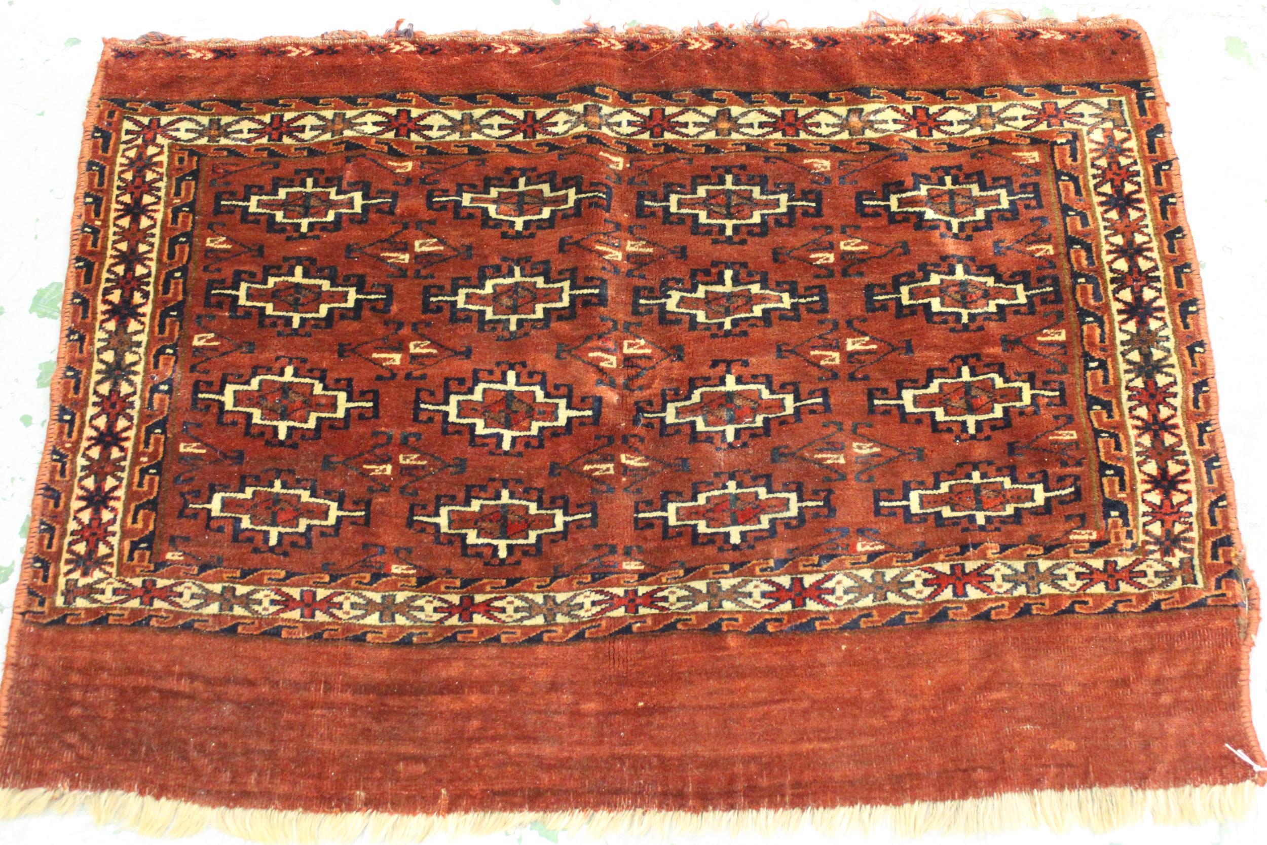 Small Turkoman tent bag with four rows of four gols, on a madder ground with skirt panel, 3ft 4ins x