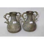 Pair of Indian Benares brass two handled baluster form vases, with engraved decoration