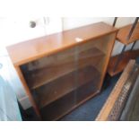 Mid 20th Century teak dwarf bookcase by Jonell with two glass sliding doors, 30ins wide x 9.5ins