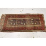 Belouch rug of all over floral design, with multiple borders, approximately 87ins x 42ins, (worn)