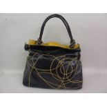 Coccinelle Ladies blue and mustard leather handbag In used but excellent condition. Very slight