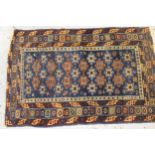 Small Belouch rug with an all over stylised flower head design on a blue ground with borders, 4ft