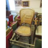 Victorian mahogany spoon back rocking chair with cane back and seat on turned supports