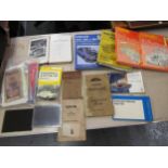 Box containing a quantity of various car instruction manuals, including Zephyr Vanguard and a