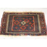 Small Belouch rug of geometric design with multiple borders, 24ins x 41ins together with another,