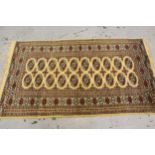 Small Pakistan Bokhara design rug, with two rows of gols, on a ivory ground with borders, 5ft 4ins x