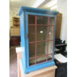 19th Century blue painted pine and mahogany bookcase, with a glazed door, enclosing shelves,