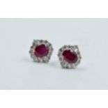 Pair of 18ct white gold treated ruby and diamond cluster earstuds, rubies 5.54ct approximately,