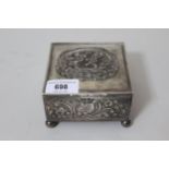 Edwardian silver square trinket box, with hinged lid and embossed with dancing cherubs, and stylised