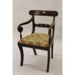 William IV mahogany carved rail back elbow chair with drop-in seat, raised on sabre supports