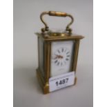 Miniature early 20th Century brass cased carriage clock, the enamel dial with Roman numerals, signed