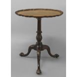 A GEORGE III MAHOGANY 'PIE CRUST' PEDESTAL TABLE, the circular tip-top with a raised wavy edged