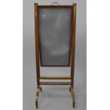 A LATE GEORGE III MAHOGANY FRAMED CHEVAL MIRROR, with a rising rectangular plate with bevelled edge,