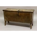 AN OAK SIX PLANK COFFER, the rectangular top with notched ends and moulded sides with stamped