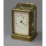A FRENCH BRASS CARRIAGE CLOCK, with white enamelled dial and two train push-button repeating