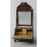 A QUEEN ANNE STYLE BUREAU FRONTED DRESSING TABLE MIRROR, the rectangular mirror beneath a wavy-edged