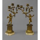 A PAIR OF LOUIS XV STYLE THREE BRANCH CANDELABRA, each with a winged putti holding aloft three