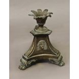 A 19TH CENTURY BRONZE CANDLESTICK IN THE MANNER OF THOMAS HOPE, with a splayed leaf form sconce on a