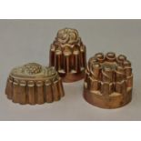 THREE VICTORIAN COPPER JELLY MOULDS, one with a pineapple moulding to the top, another marked for