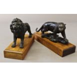 A BRONZE SCULPTURE OF A PROWLING LION AND ANOTHER. the lion with patinated finish standing on a