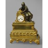 A FRENCH ORMOLU EMPIRE STYLE MANTLE CLOCK, the white enamelled dial with Roman numerals, with a