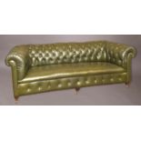 A LARGE GREEN LEATHER UPHOLSTERED CHESTERFIELD, with a broad button upholstered back, on short