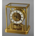 A JAEGER LE COULTRE ATMOS CLOCK, of traditional design with glass and brass case, the mechanism
