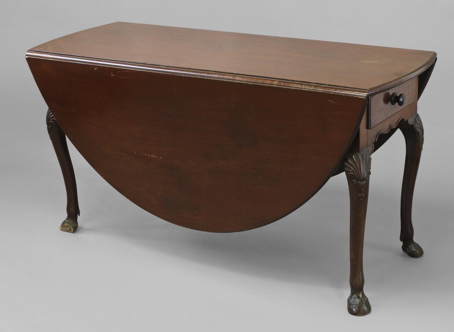 A GEORGE II IRISH MAHOGANY GATELEG DINING TABLE, the broad oval top above twin frieze drawers, on