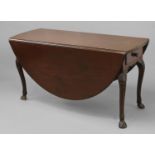 A GEORGE II IRISH MAHOGANY GATELEG DINING TABLE, the broad oval top above twin frieze drawers, on