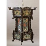 A CHINESE HARDWOOD FRAMED HANGING LANTERN, of hexagonal form with carved and pierced structural