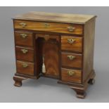 A GEORGE II/III MAHOGANY KNEEHOLE WRITING DESK, with a rectangular top with moulded border above