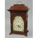 A MAHOGANY CASED BRACKET CLOCK WITH A PAINTED DIAL, the arched dial with a painted chapter ring with