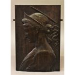 A LOW RELIEF CARVED PANEL, a rectangular mahogany panel carved in low relief with a female saint