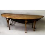 AN IRISH WAKE STYLE MAHOGANY DROP FLAP TABLE, the broad oval drop flap top on eight cabriole legs