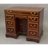 A GEORGE III STYLE MAHOGANY KNEEHOLE WRITING DESK, the rectangular top with moulded border and